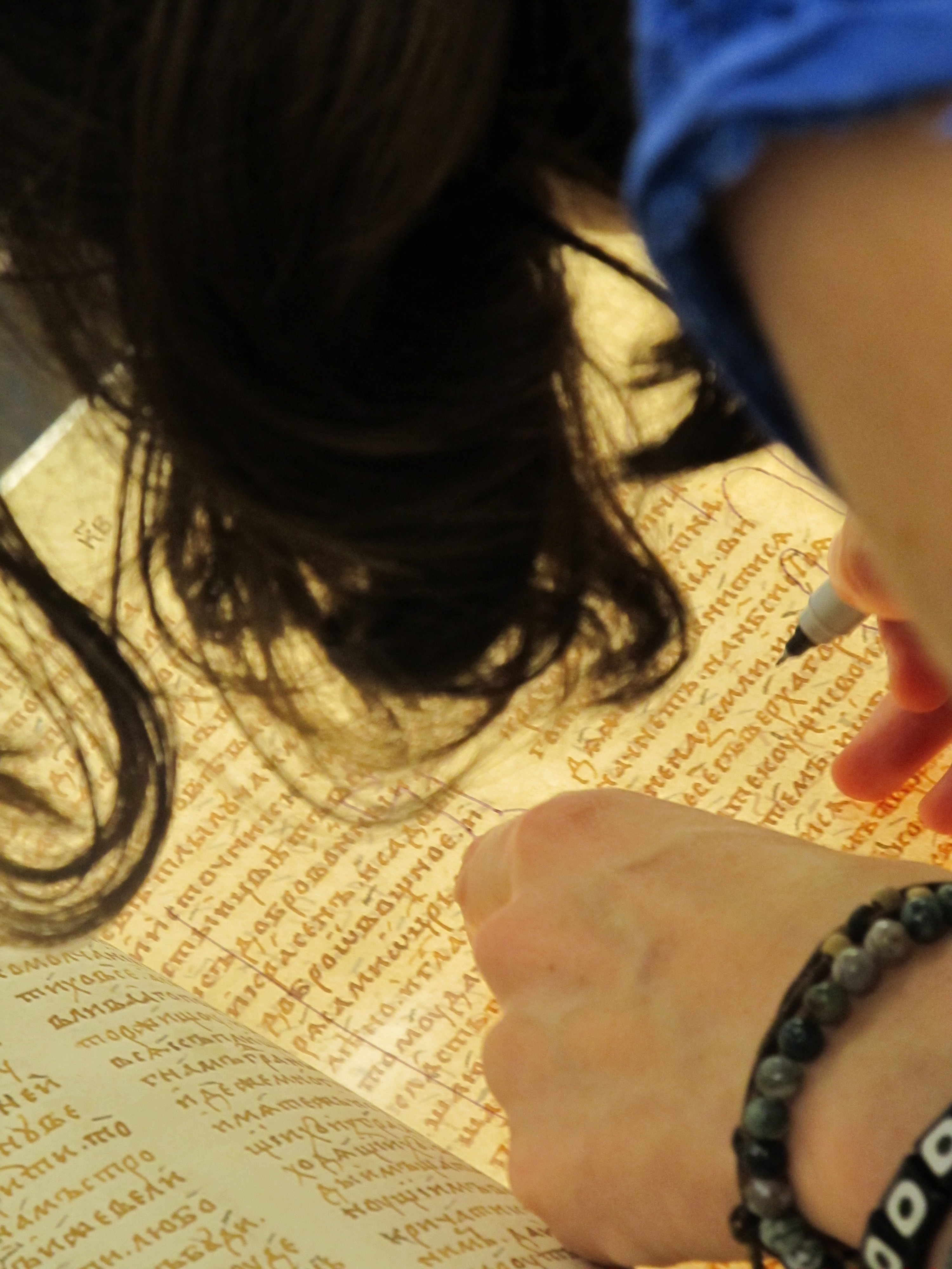 Participant uses a cold nose illuminator to examine the manuscript