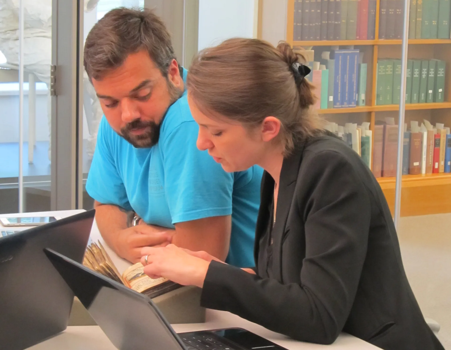 Participants looking over a manuscript