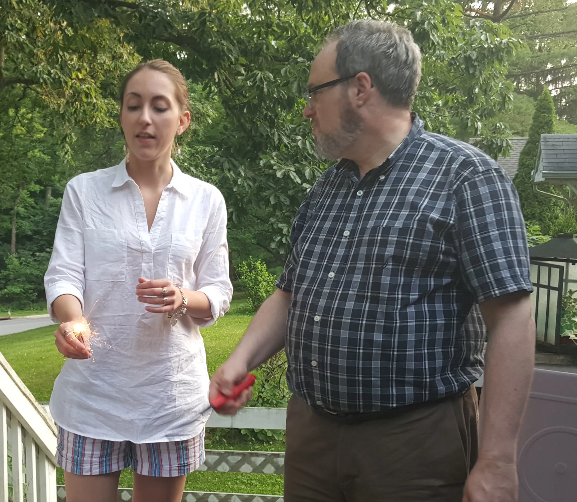 Dan Collins stands talking with a participant on his porch at home