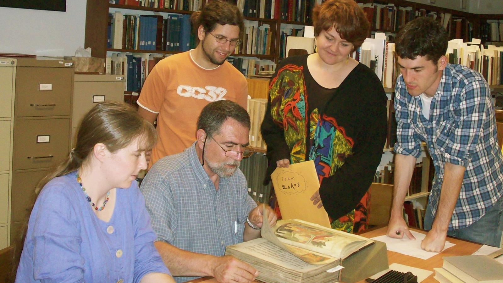 2008 Participants look over manuscripts with Predrag